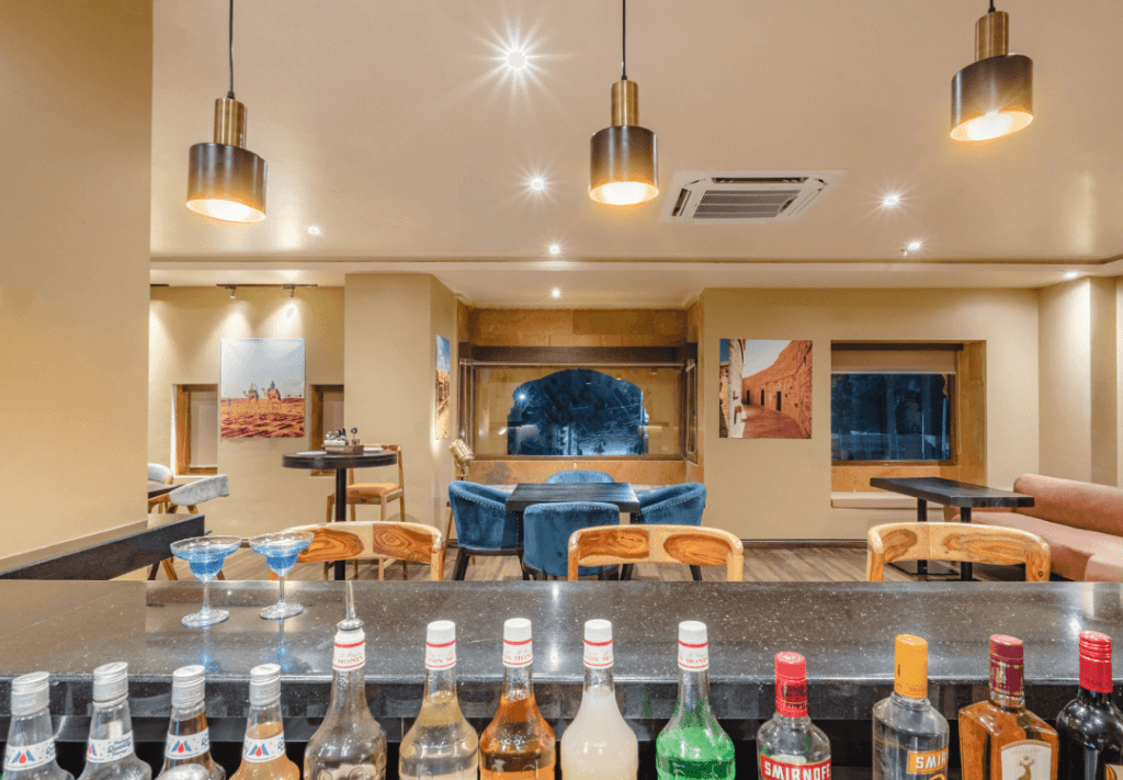 a bar with drinks and chairs