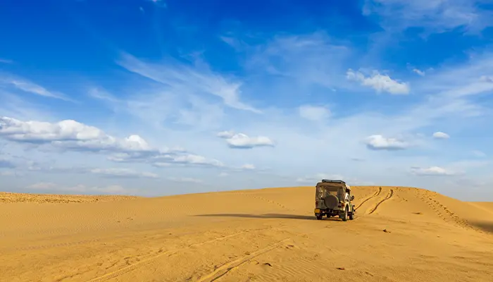 a vehicle driving in a desert